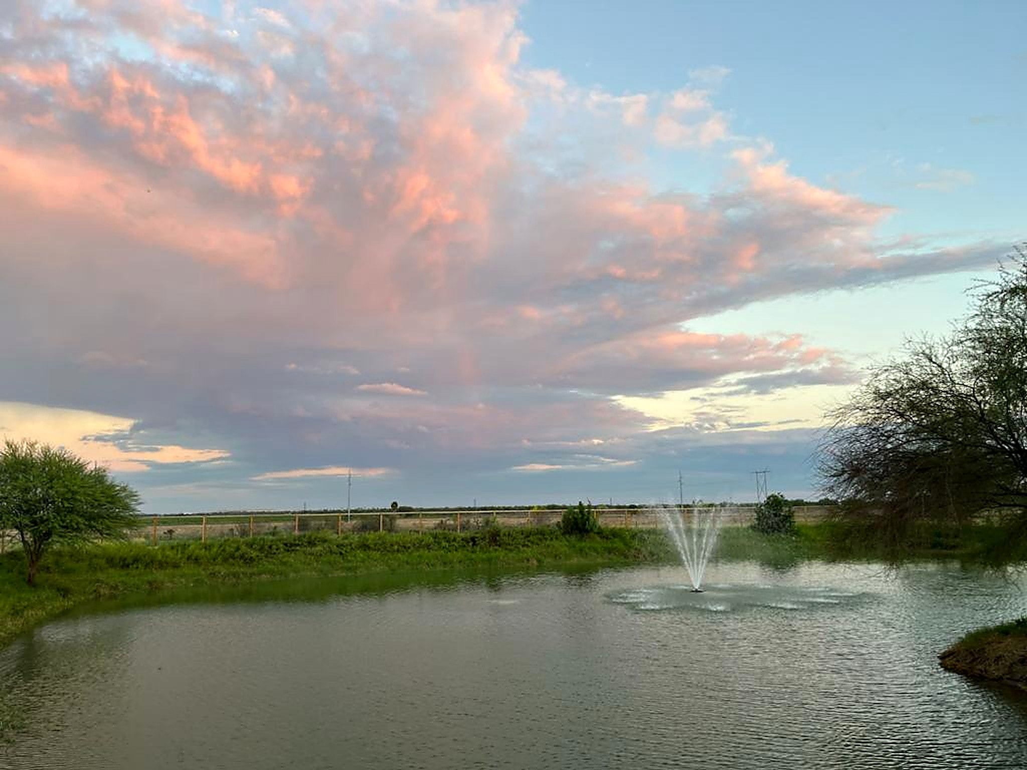 Evening clouds over the community pond at Rio Grande Estates