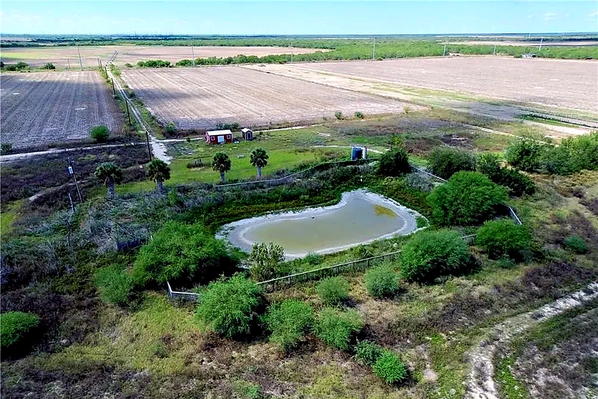 Aerial view showing the community pond within the 50 acres at Rio Grande Estates